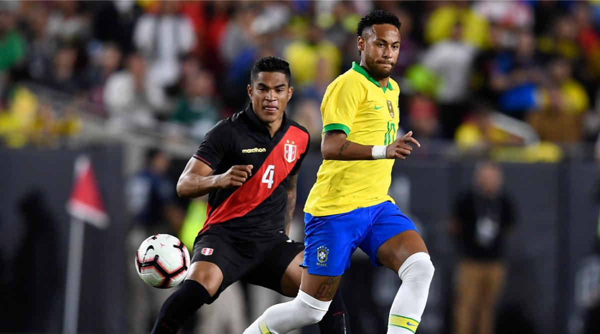 Sep 10, 2019; Los Angeles, CA, USA; Brazil forward Neymar (10) passes the ball in front of Peru defender Anderson Santamaria (4) during the the second half of the South American Showdown soccer match at Los Angeles Coliseum.